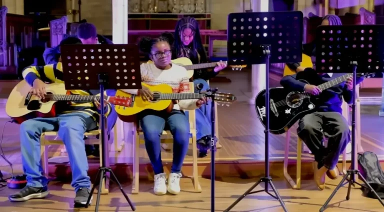 Children playing guitars at an MRF session